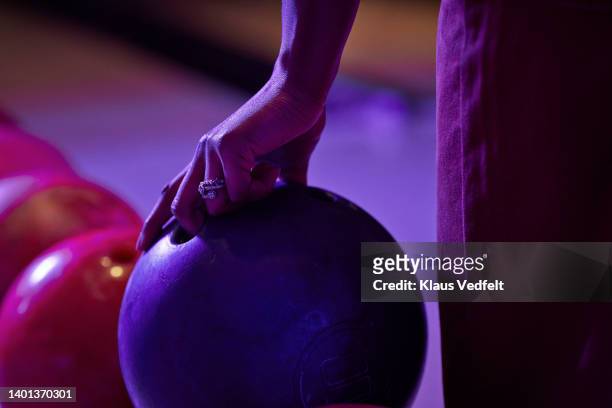 woman lifting bowling ball - bowling ball stock pictures, royalty-free photos & images