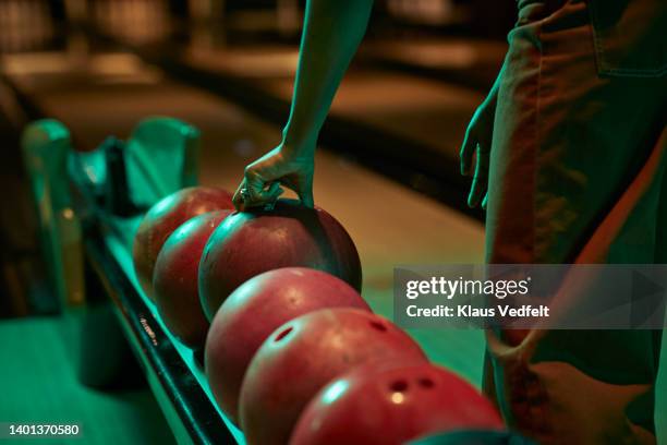 woman picking bowling ball - bowling ball stock pictures, royalty-free photos & images