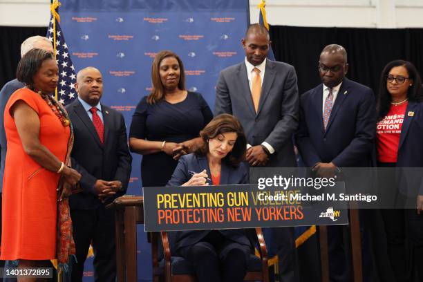 Gov. Kathy Hochul signs legislation as she is surrounded by lawmakers during a bill signing ceremony at the Northeast Bronx YMCA on June 06, 2022 in...