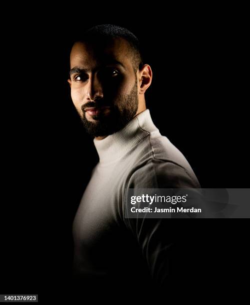 young man face - young caucasian man on black stock pictures, royalty-free photos & images