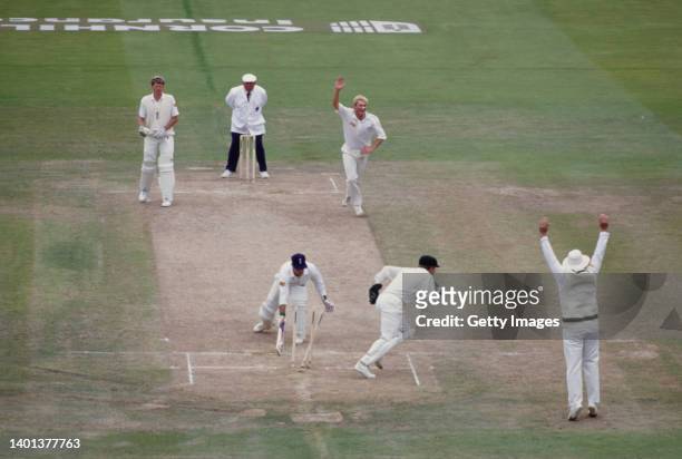 Australia leg spinner Shane Warne celebrates after taking the wicket of Graham Thorpe, stumped by Ian Healey for 60 runs as non striker Peter Such...