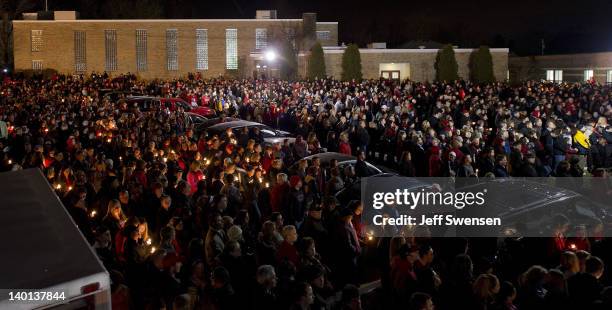 Students and those in the community embrace one another as they hold a candlelight vigil at St Mary's of the Assumption Church on February 28, 2012...