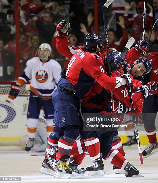 The Washington Capitals celebrate the game tying goal against the New York Islanders at 19:34 of the third period at the Verizon Center on February...