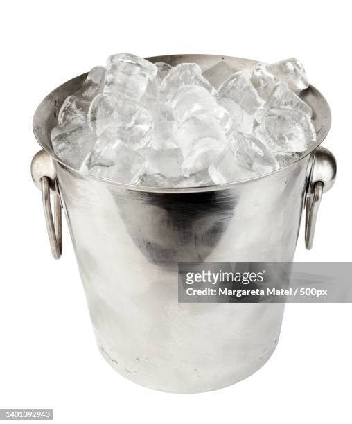 close-up of ice bucket against white background - champagne bucket stock pictures, royalty-free photos & images