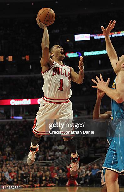 Derrick Rose of the Chicago Bulls puts up a shot against Chris Kaman of the New Orleans Hornets on his way to a game-high 32 points at the United...