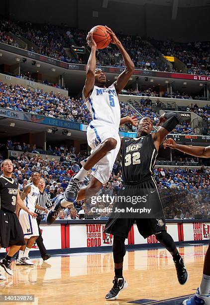 Will Barton of the Memphis Tigers shoots against Isaiah Sykes of the UCF Knights on February 28, 2012 at FedExForum in Memphis, Tennessee.