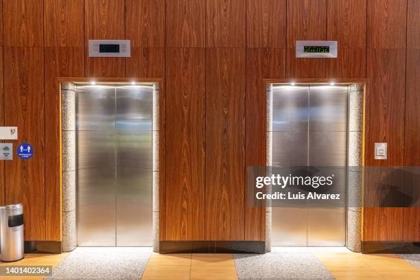 elevators in a modern hotel building - lift stockfoto's en -beelden