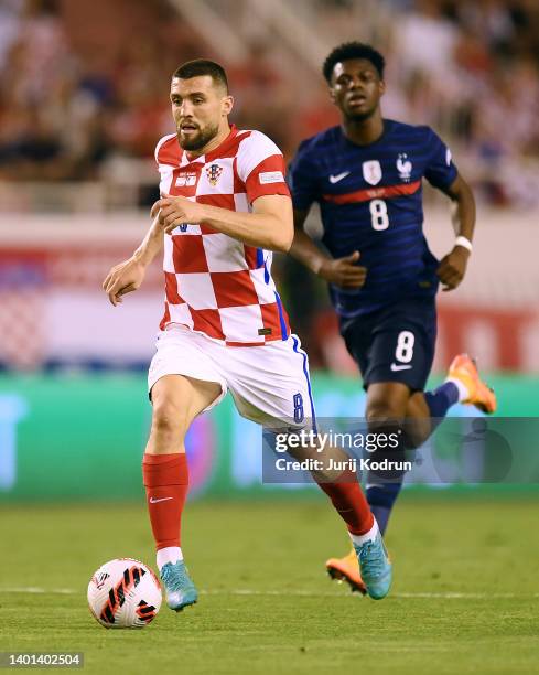 Mateo Kovacic of Croatia runs with the ball whilst under pressure from Aurelien Tchouameni of France during the UEFA Nations League League A Group 1...