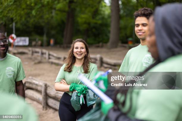 meeting of volunteers team in park - discussion germany outdoor friends stock-fotos und bilder