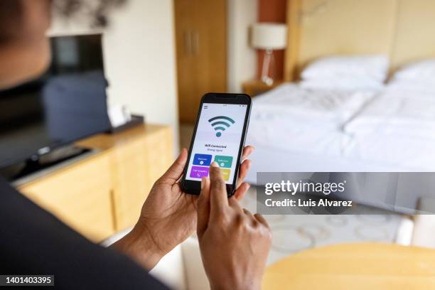 close-up of a businesswoman connecting to the mobile wifi in hotel room - つながる ストックフォトと画像