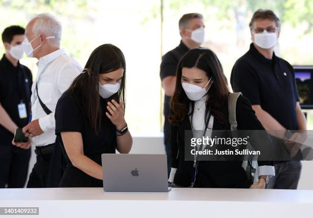 An attendee looks at a newly redesigned MacBook Air laptop during the WWDC22 at Apple Park on June 06, 2022 in Cupertino, California. Apple CEO Tim...