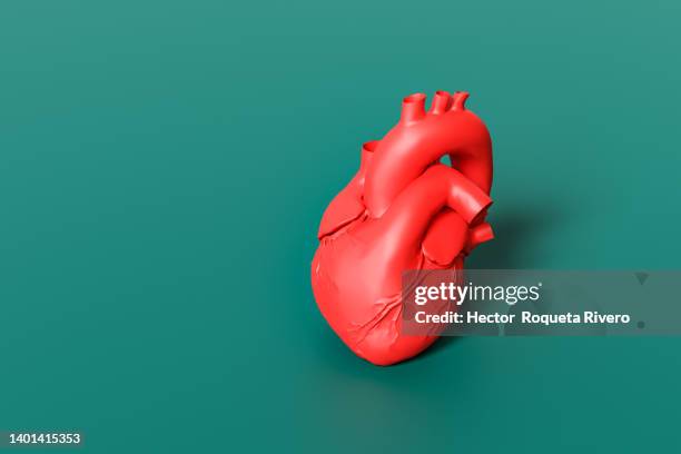 red human heart on green background. 3d render - heart shape 3d stock pictures, royalty-free photos & images