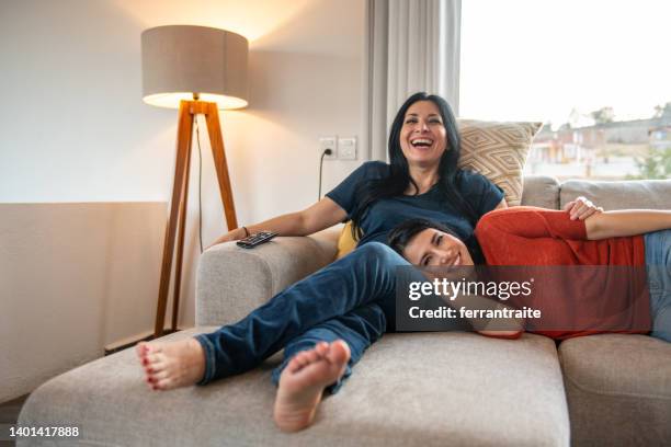 lesbian couple watching tv - girlfriends films stock pictures, royalty-free photos & images