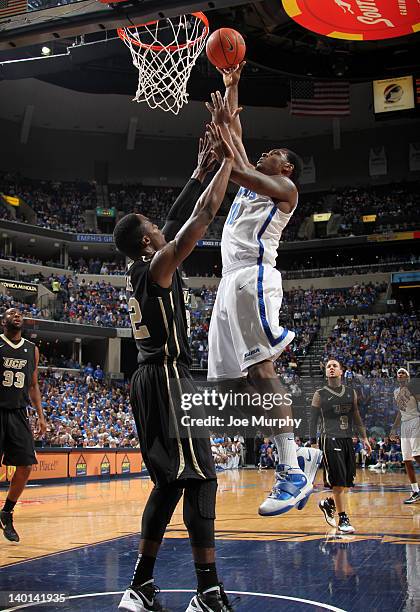 Tarik Black of the Memphis Tigers shoots over Isaiah Sykes of the UCF Knights on February 28, 2012 at FedExForum in Memphis, Tennessee. Memphis beat...