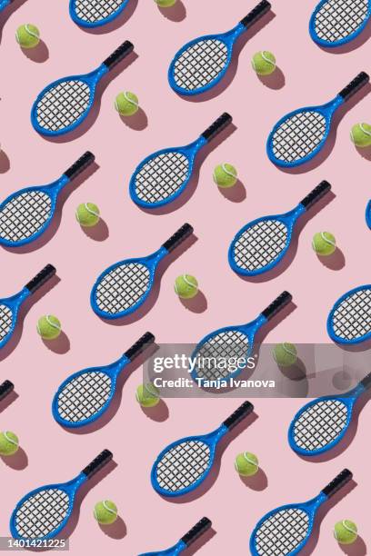 tennis rackets and balls on pink background - tennis racquet isolated stock pictures, royalty-free photos & images