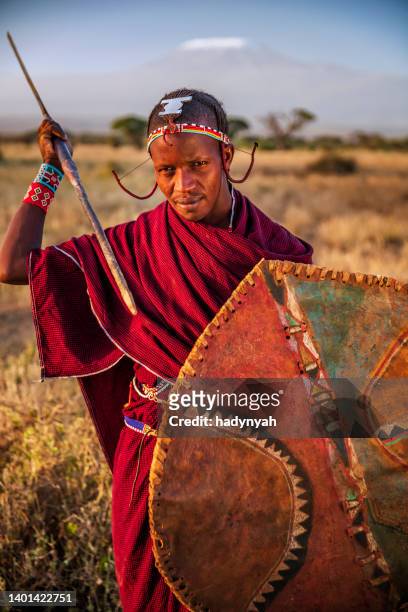 warrior from maasai tribe, mount kilimanjaro on background, kenya, africa - amboseli national park bildbanksfoton och bilder