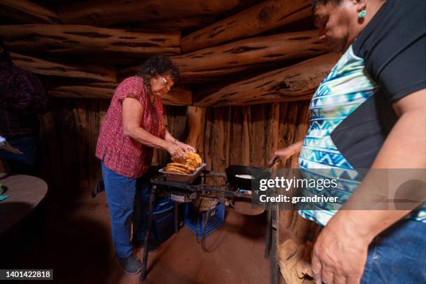 two women in their family hogan cooking up  some fry bread to make navajo tacos for their family - indian food bildbanksfoton och bilder
