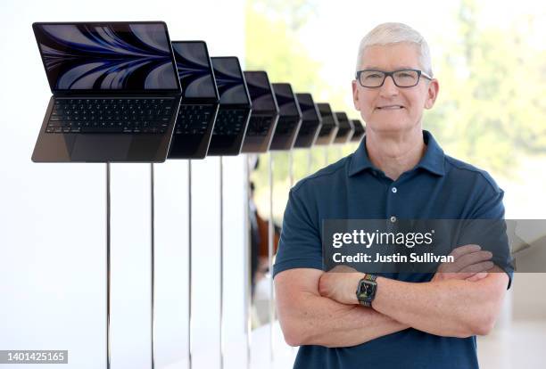 Apple CEO Tim Cook stands next to a display of newly redesigned MacBook Air laptop during the WWDC22 at Apple Park on June 06, 2022 in Cupertino,...