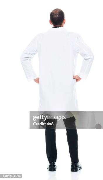 caucasian male doctor standing in front of white background wearing lab coat - male buttocks stockfoto's en -beelden