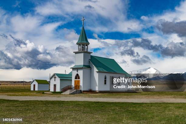 picturesque church at the foot of the crazy mountains - steeple stock pictures, royalty-free photos & images
