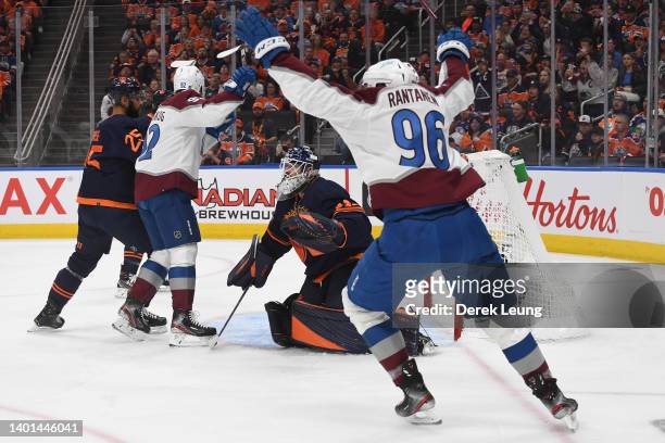 Mikko Rantanen and Gabriel Landeskog of the Colorado Avalanche react after teammate Cale Makar scores a goal against Mike Smith of the Edmonton...