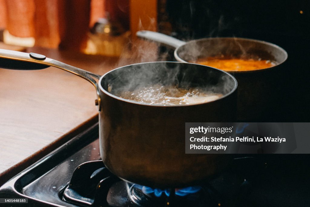 Soup Boiling in Cooking Pans on Gas Burning Stove