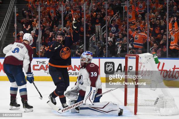 Zach Hyman of the Edmonton Oilers celebrates after a goal is score by teammate Connor McDavid against Pavel Francouz of the Colorado Avalanche during...