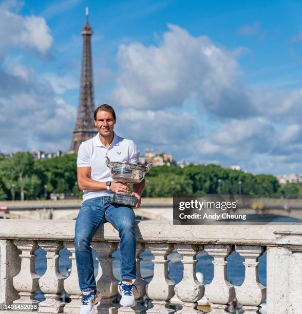 Rafael Nadal of Spain poses with the Musketeers Cup at the photocall after winning his 14th Roland Garros Grand Chelem title on Pont Alexandre III...