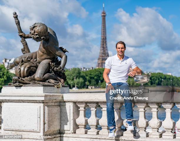 Rafael Nadal of Spain poses with the Musketeers Cup at the photocall after winning his 14th Roland Garros Grand Chelem title on Pont Alexandre III...