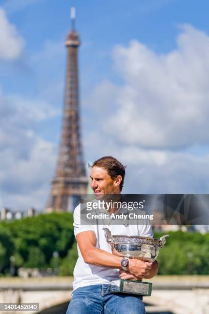 Rafael Nadal of Spain poses with the Musketeers Cup at the photocall after winning his 14th Roland Garros Grand Chelem title on Pont Alexandre III...