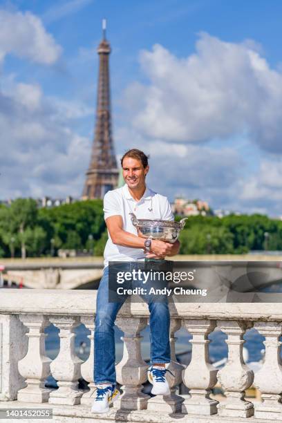 Rafael Nadal of Spain poses with the Musketeers Cup at the photocall after winning his 14th Roland Garros Grand Chelem title on Pont Alexandre III...