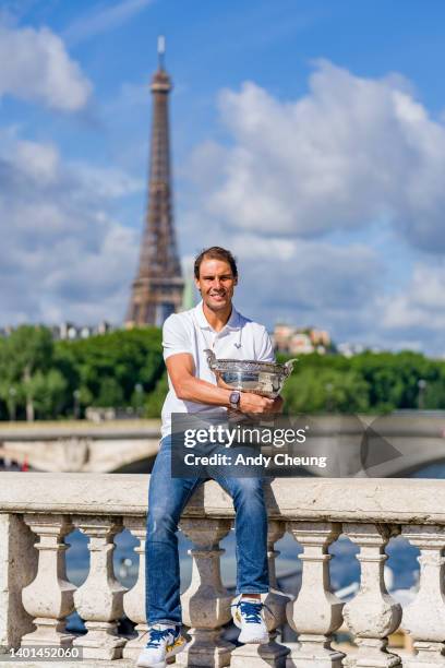 Rafael Nadal of Spain poses with the Musketeers Cup at the photocall after winning his 14th Roland Garros Grand Chelem title on Pont Alexandre III...