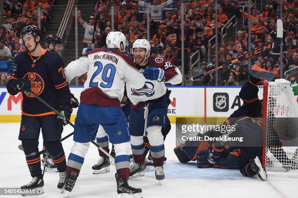 Nathan MacKinnon of the Colorado Avalanche celebrates with Gabriel Landeskog after scoring a goal against Mike Smith of the Edmonton Oilers during...