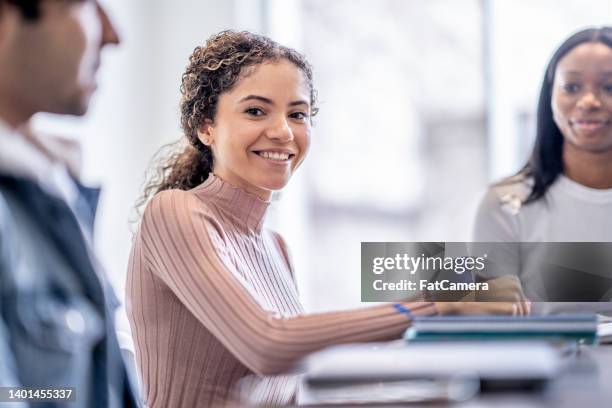 female university student studying with peers - financial literacy stock pictures, royalty-free photos & images