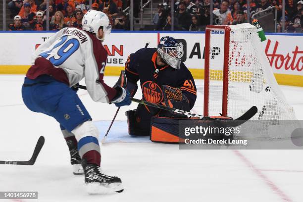 Nathan MacKinnon of the Colorado Avalanche scores a goal against Mike Smith of the Edmonton Oilers during the third period in Game Four of the...