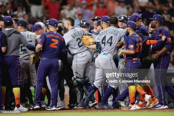 Houston Astros and Seattle Mariners benches clear after Ty France of the Seattle Mariners was hit by a pitch during the ninth inning at Minute Maid...