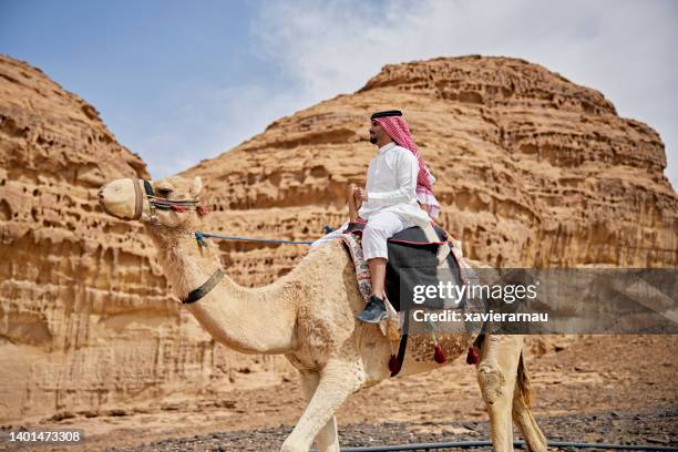 outdoor portrait of camel driver on tourist trek in desert - thawb stock pictures, royalty-free photos & images