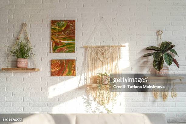 bohemian living room interior, white brick wall. sunny day. - macrame stock pictures, royalty-free photos & images