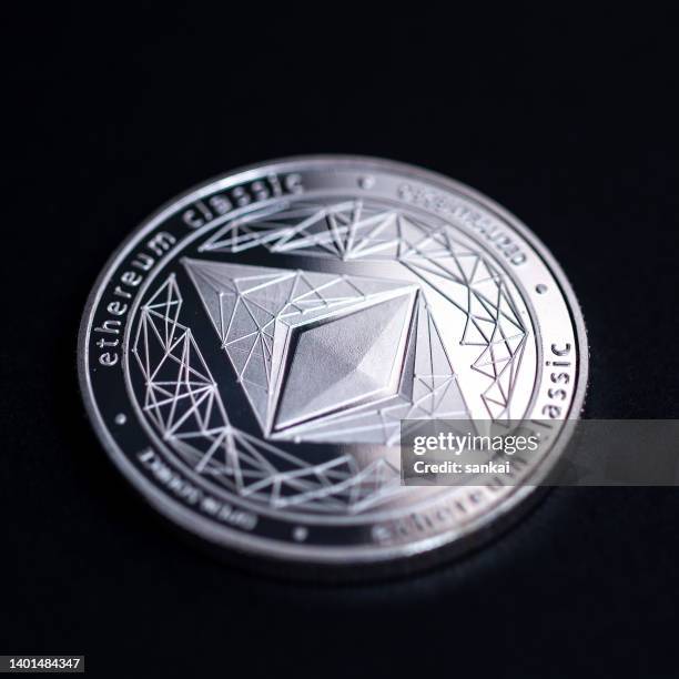 studio shot of silver coin with ethereum symbol isolated on black background - ethereum stockfoto's en -beelden