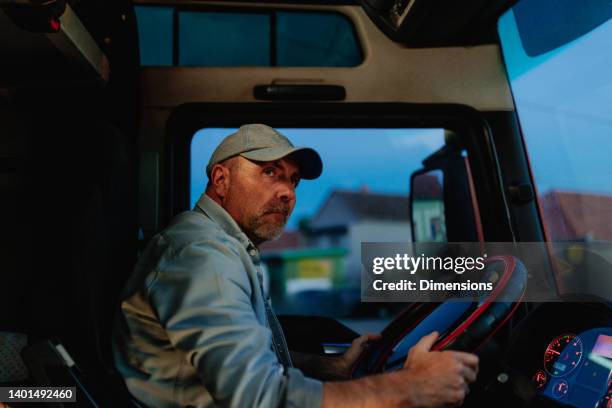 adult man turning the wheel of a truck - truck turning stock pictures, royalty-free photos & images