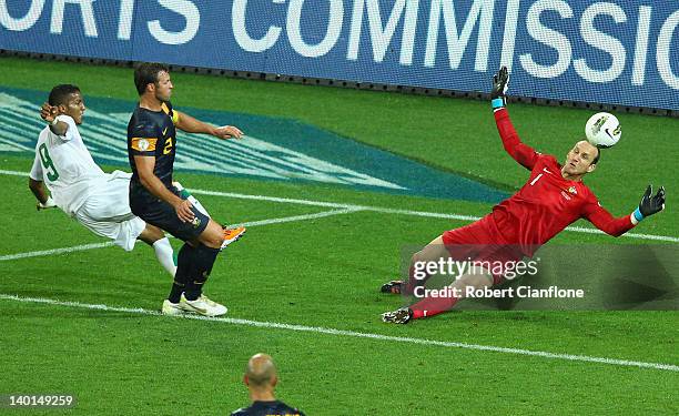 Australian goalkeeper Mark Schwarzer makes a save off Naif Ahmed Hazazi of Saudi Arabia during the Group D 2014 FIFA World Cup Asian Qualifier match...