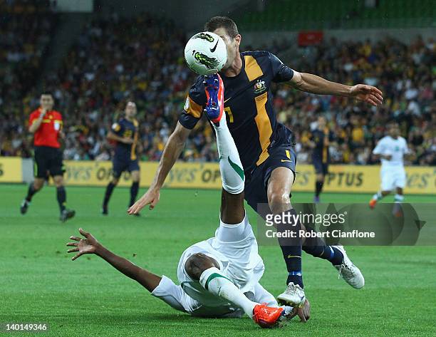 Brett Emerton of Australia is challenged by Kamil Saddiq of Saudi Arabia during the Group D 2014 FIFA World Cup Asian Qualifier match between...