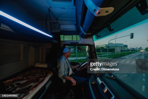 the truck driver is driving through the city - truck turning stock pictures, royalty-free photos & images