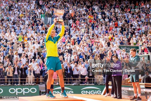 Rafael Nadal of Spain raises the winners trophy watched by French Tennis Federation President Gilles Moretton, Billie Jean King and Casper Rudd after...