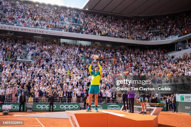 Rafael Nadal of Spain raises the winners trophy watched by French Tennis Federation President Gilles Moretton, Billie Jean King and Casper Rudd after...