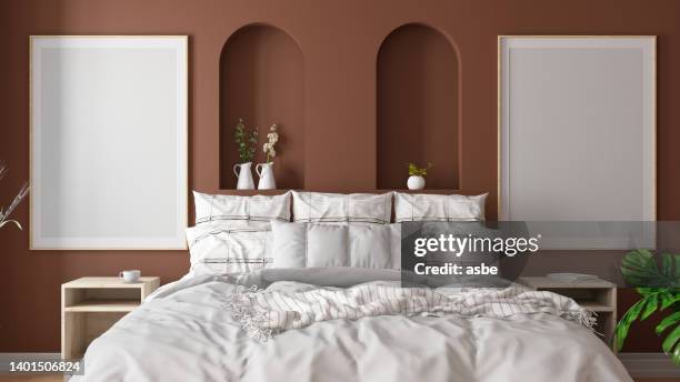 modern bedroom interior with 2 empty mockup picture frames bed and accessories - beige bedroom stock pictures, royalty-free photos & images