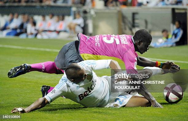 Marseille's Ghanaian forward Andre Ayew vies with Evian's Ghanean defender Jonathan Mensah during the French L1 football match Marseille vs. Evian...