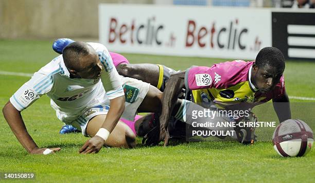 Marseille's Ghanaian forward Andre Ayew vies with Evian's Ghanean defender Jonathan Mensah during the French L1 football match Marseille vs. Evian...