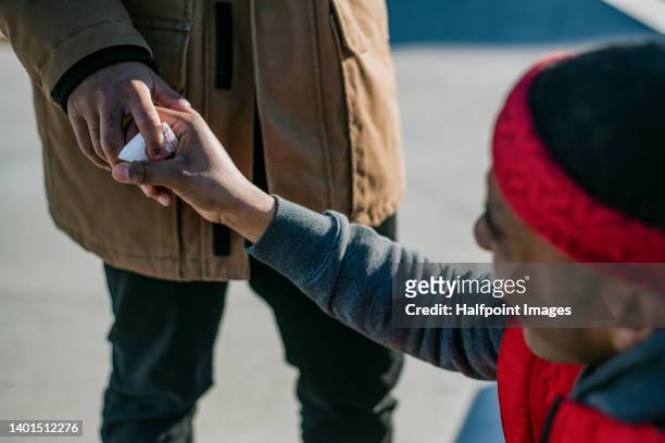 two young men dealing drugs in the street - drug addiction stock pictures, royalty-free photos & images