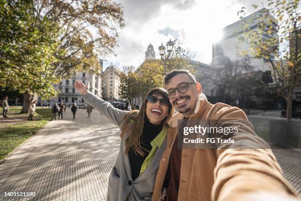 selfie of a happy young couple exploring the city - buenos aires street stock pictures, royalty-free photos & images